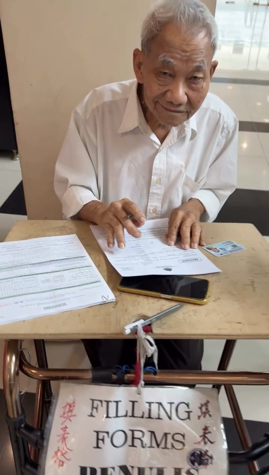 M'sian Man Charges As Low As RM5 To Help People Fill Up Forms At KDN Jalan Duta