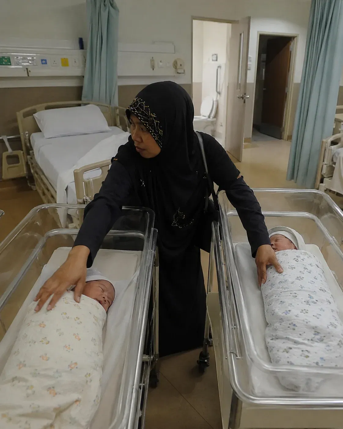 wk woman checking over newborn bassinets