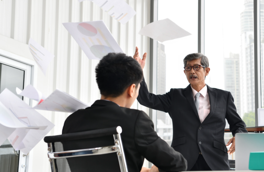 Angry boss tossing papers
