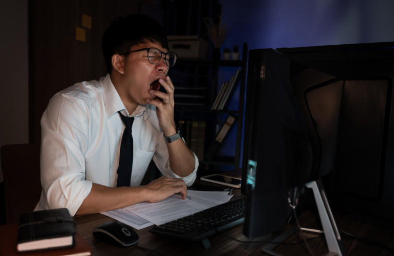 Man yawning while at work
