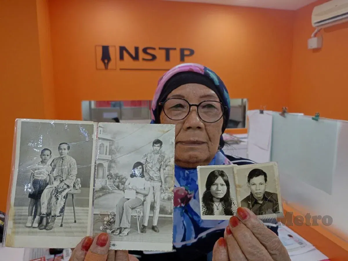 a malaysian mother showing photograph of her children