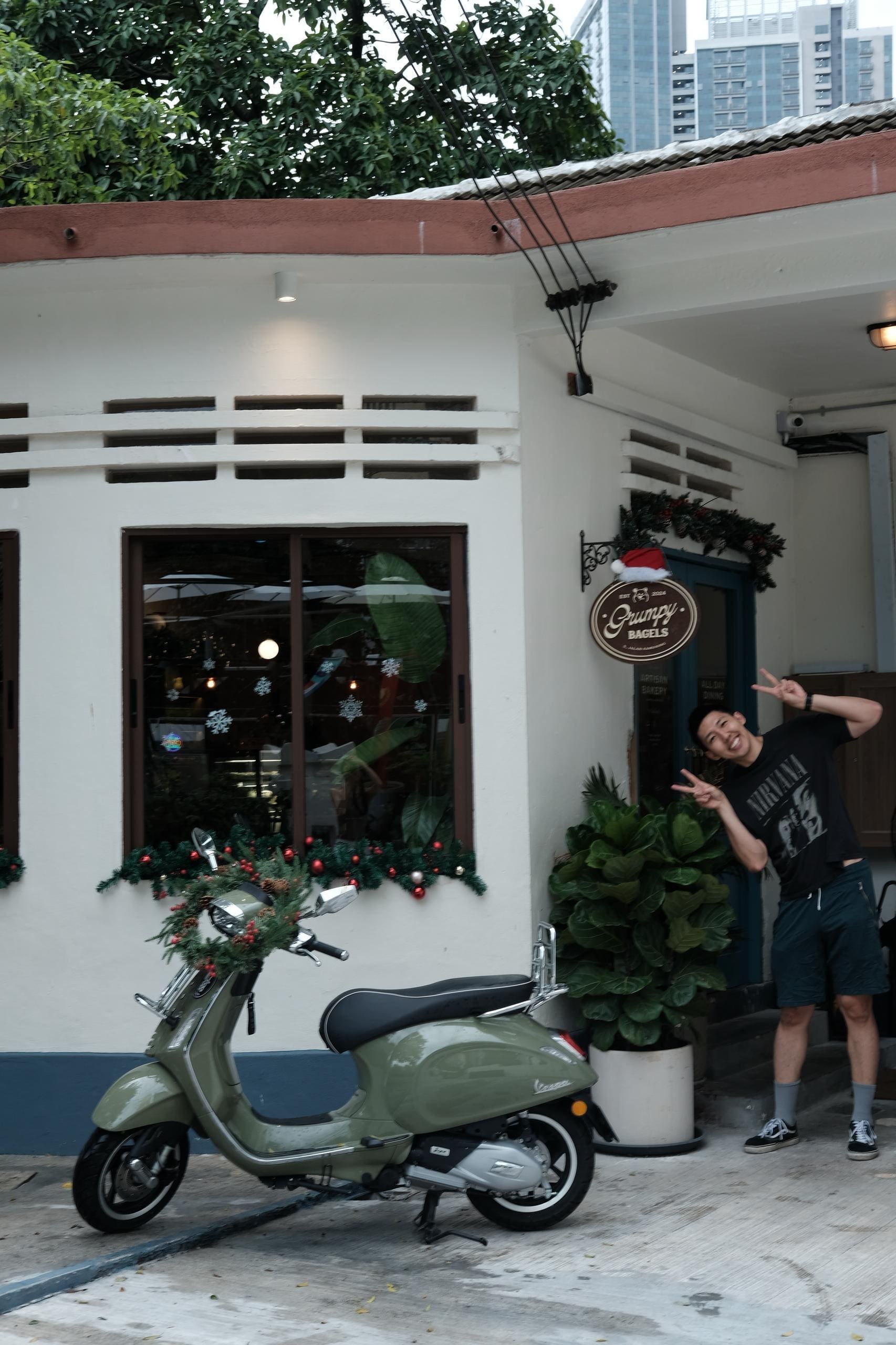 Claire's husband posing in front of Grumpy Bagels
