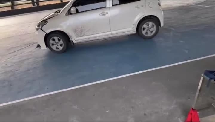 Crashes the car into the basketball court