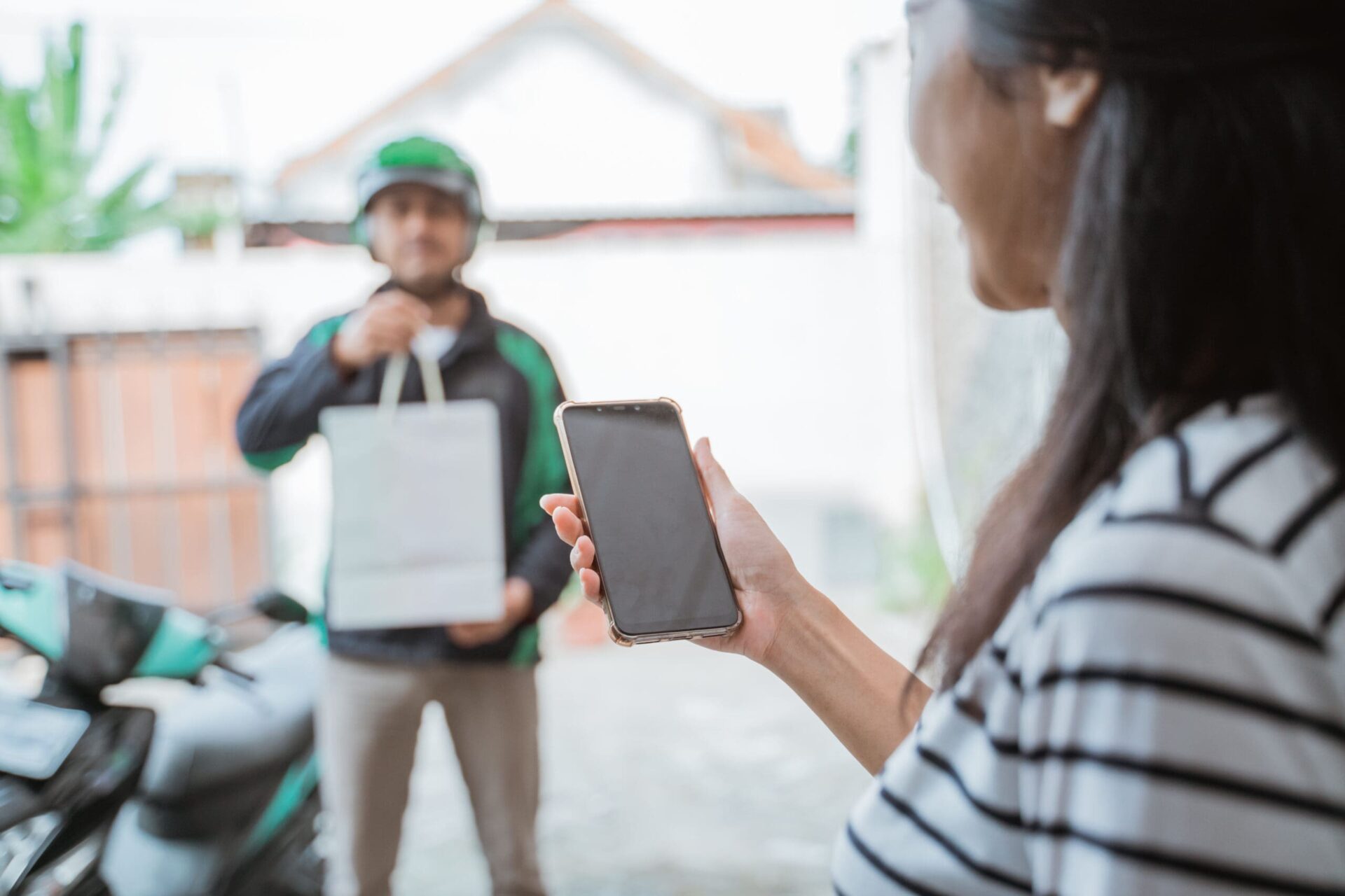 Delivery rider arrives at customer's home