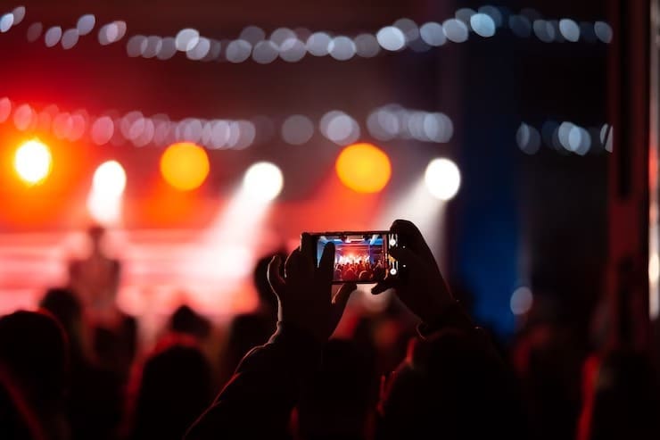 Man taking picture of a concert