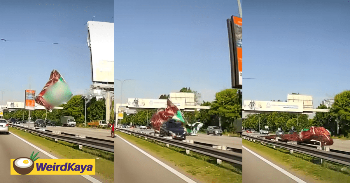 Giant Banner Falls From Billboard, Lands On & Covers Moving Car Along Busy M'sian Highway