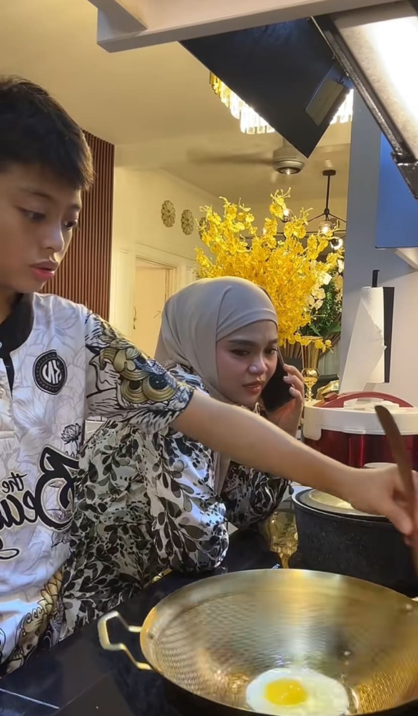 Mum monitoring her son frying egg