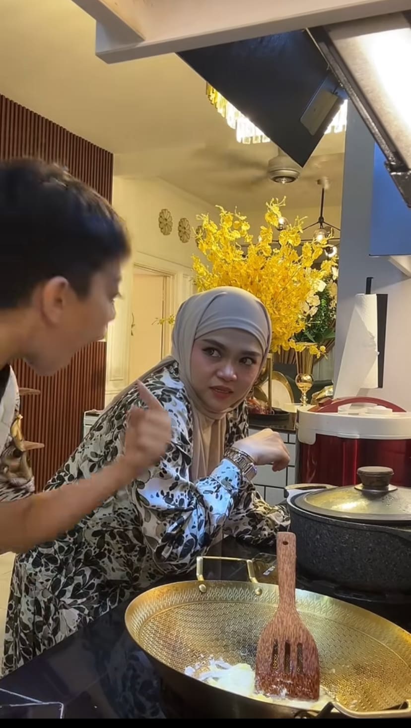 Son signalling his mum to talk instead of giving signal to teach him how to cook instead of talking on the phone