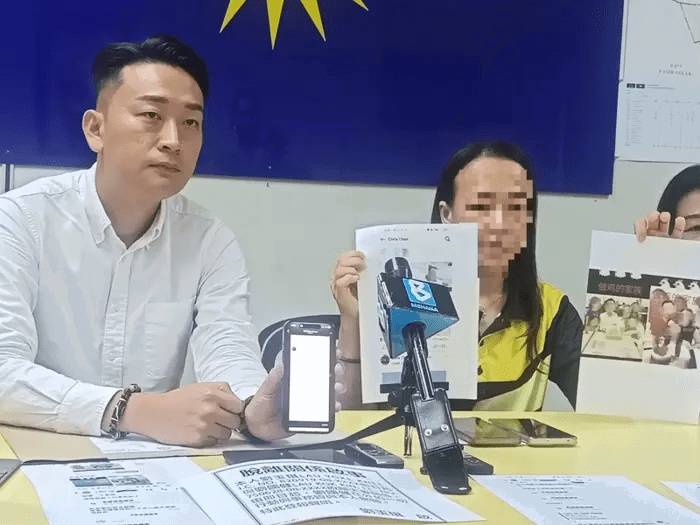 Lau speaking at press conference