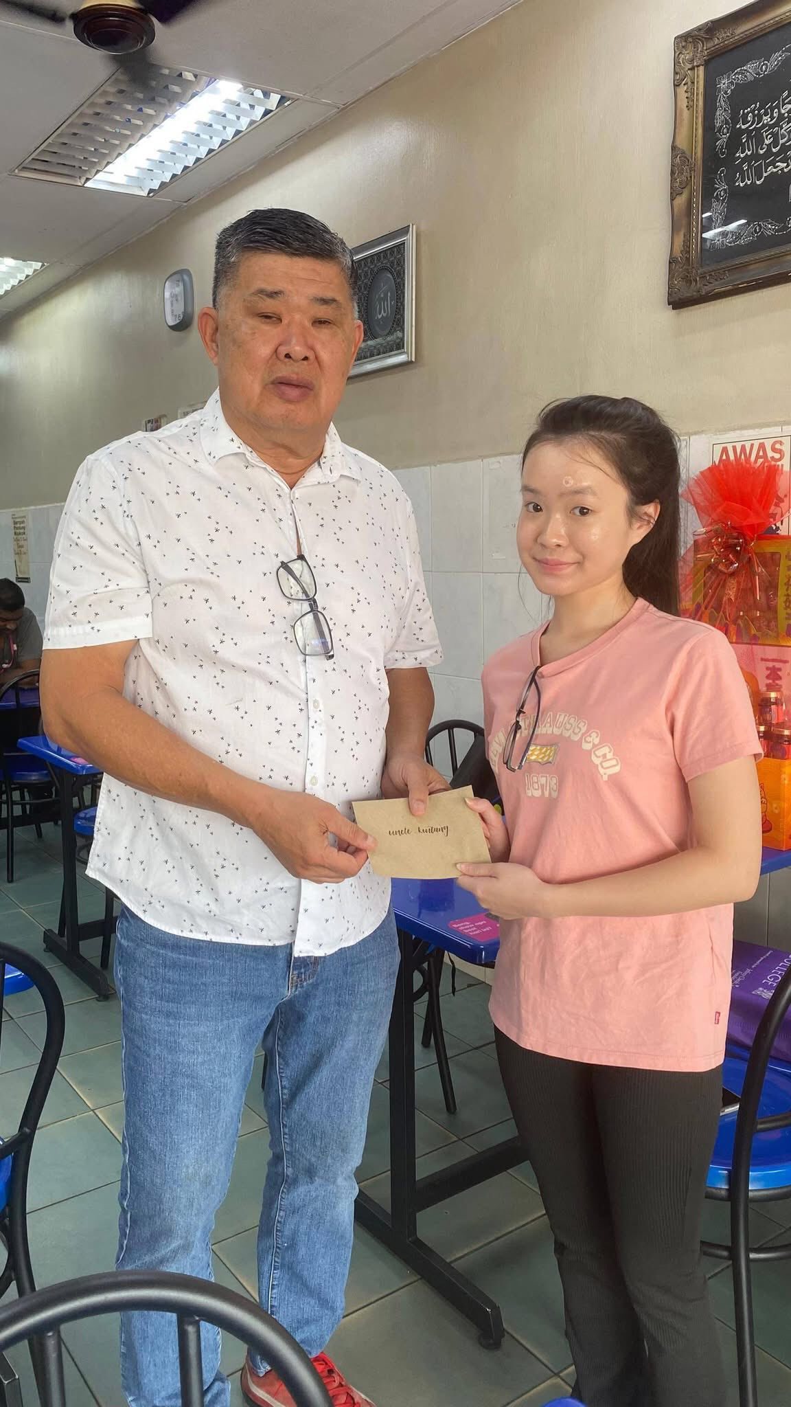 malaysian girl giving letter to uncle kentang
