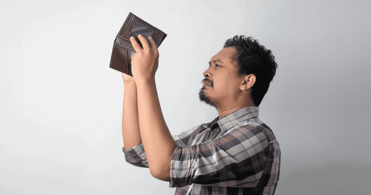 man looking at his wallet
