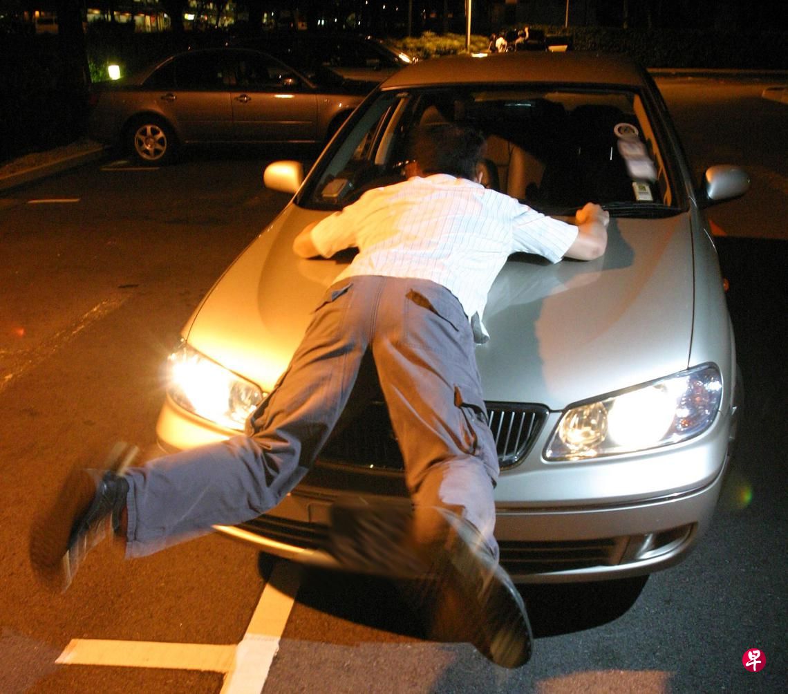 Man on car bonnet