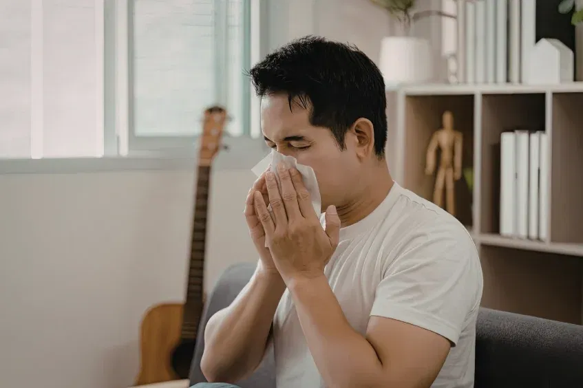 man sneezing