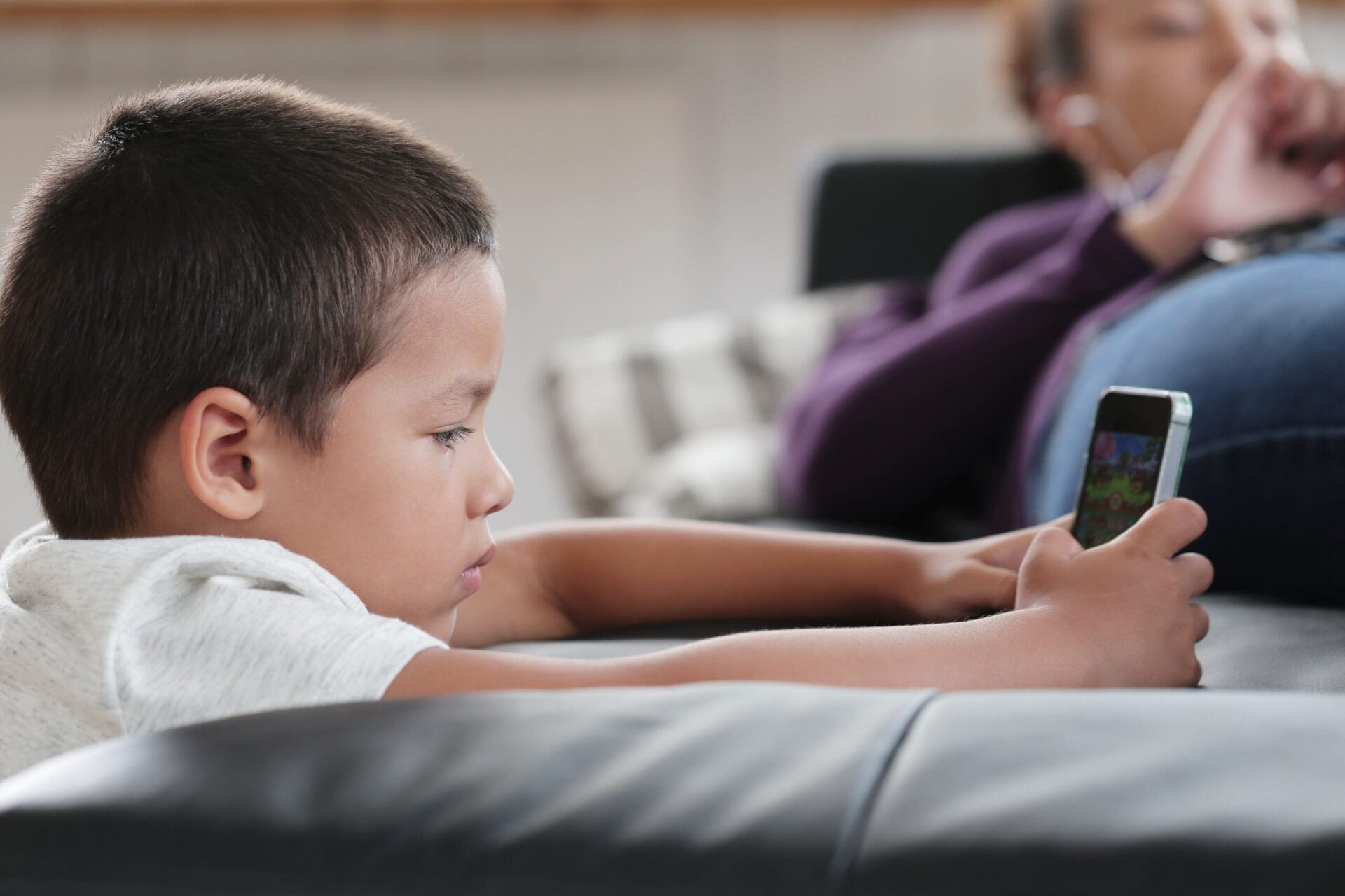 Boy playing game on phone