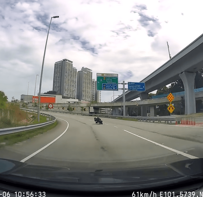 motorcyclist doing dangerous stunt on road