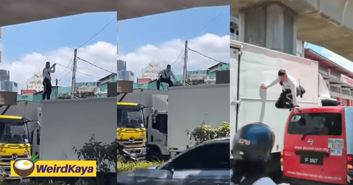 M'sian Traffic Officer Bravely Removes Electrical Wires Tangled Around Lorry With His Bare Hands