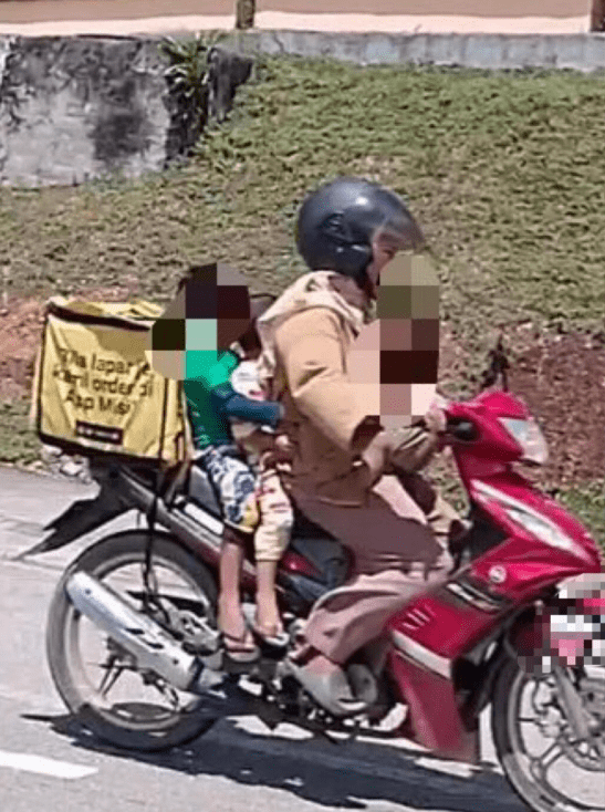 Noryani Syakira Yaakob with her kids at work