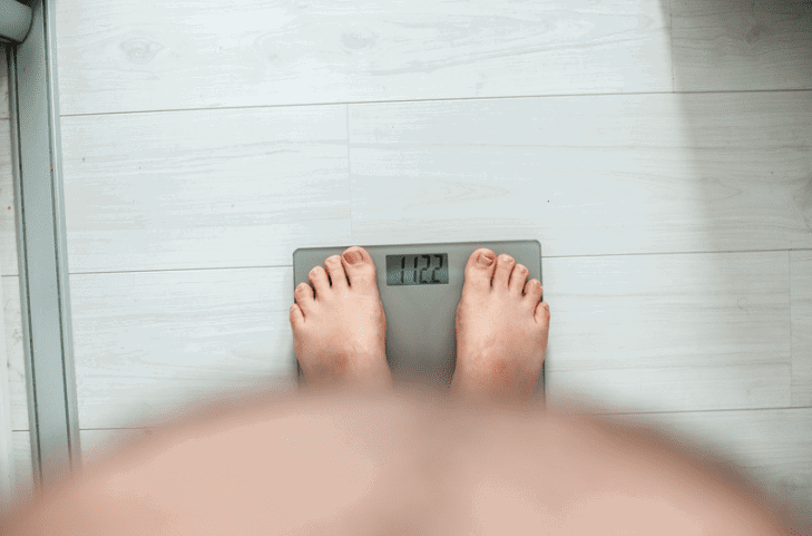 Obese man on the weighing scale