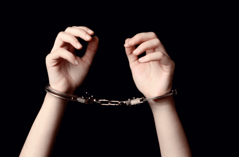 Pair of hands in handcuffs
