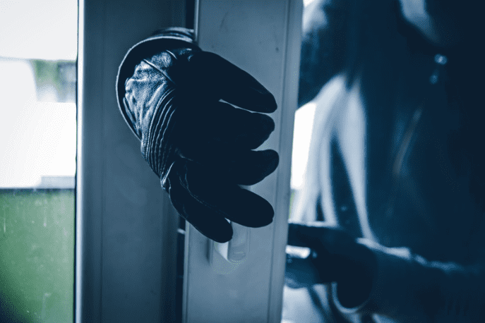 Robber breaking into a house