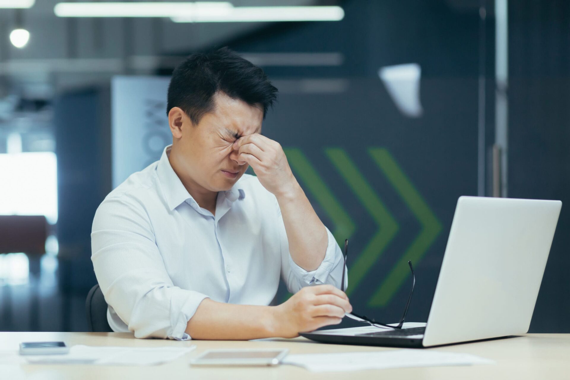 Distressed Asian man sitting in front of the laptop