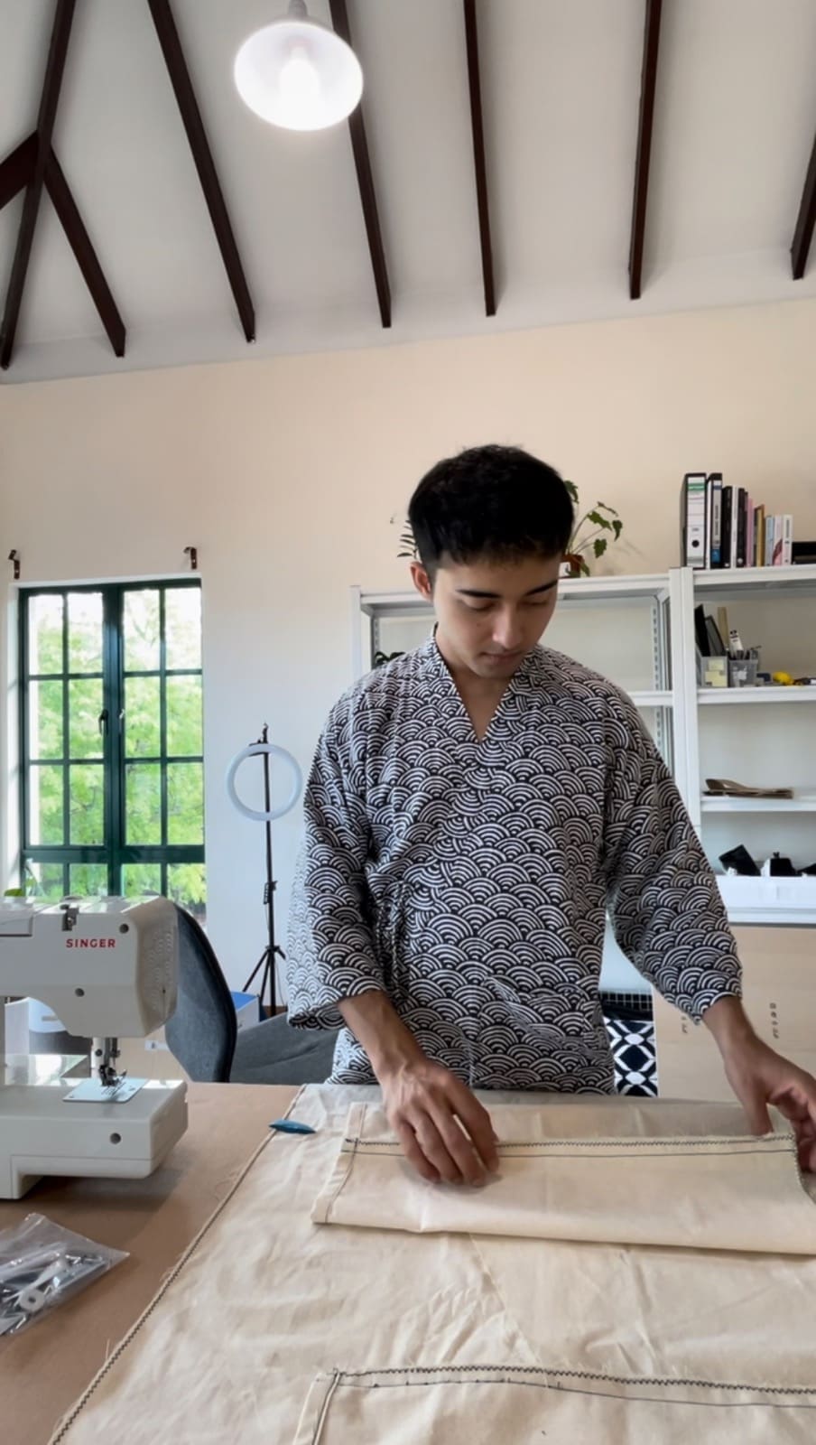 Juju preparing and measuring his Kimonos