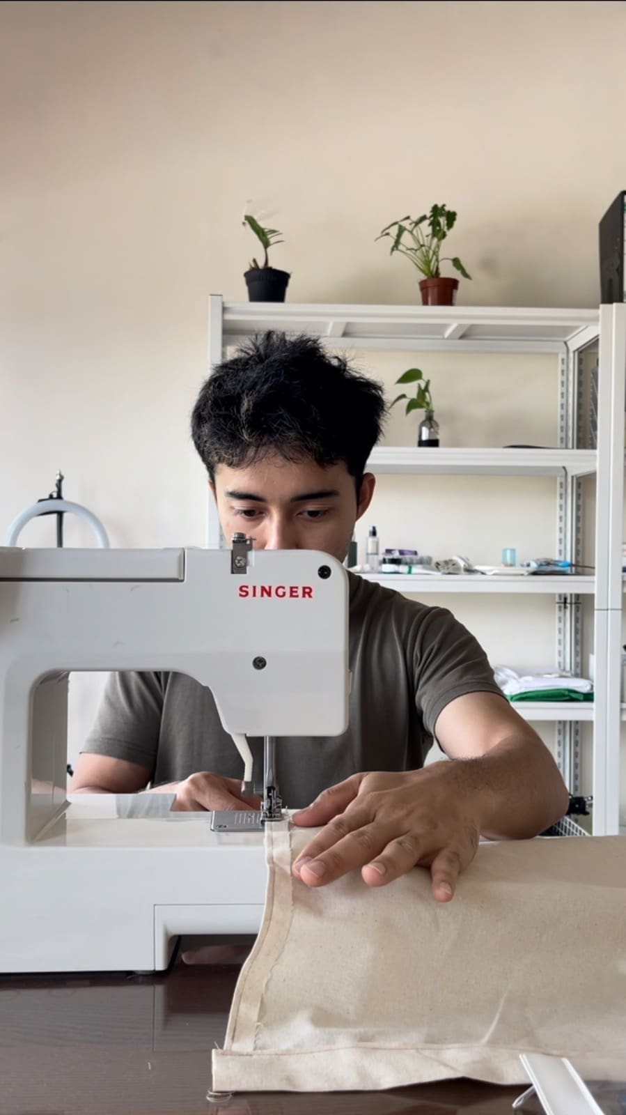 Juju stitching Kimonos that he designed