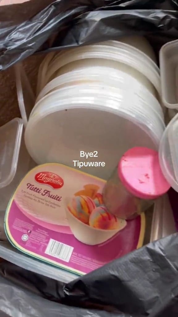 Unused Tupperware thrown in a black plastic bag