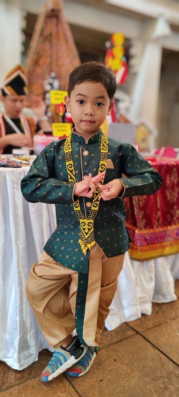 6-year-old Malaysian boy, Muhammad Nurhaq wearing in traditional attire while in posing Bharatanatyam pose.