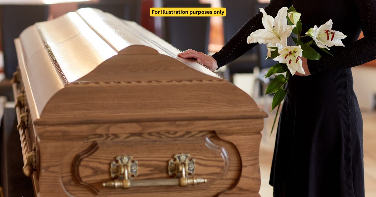 woman standing beside coffin