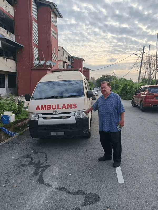Ye posing with ambulance