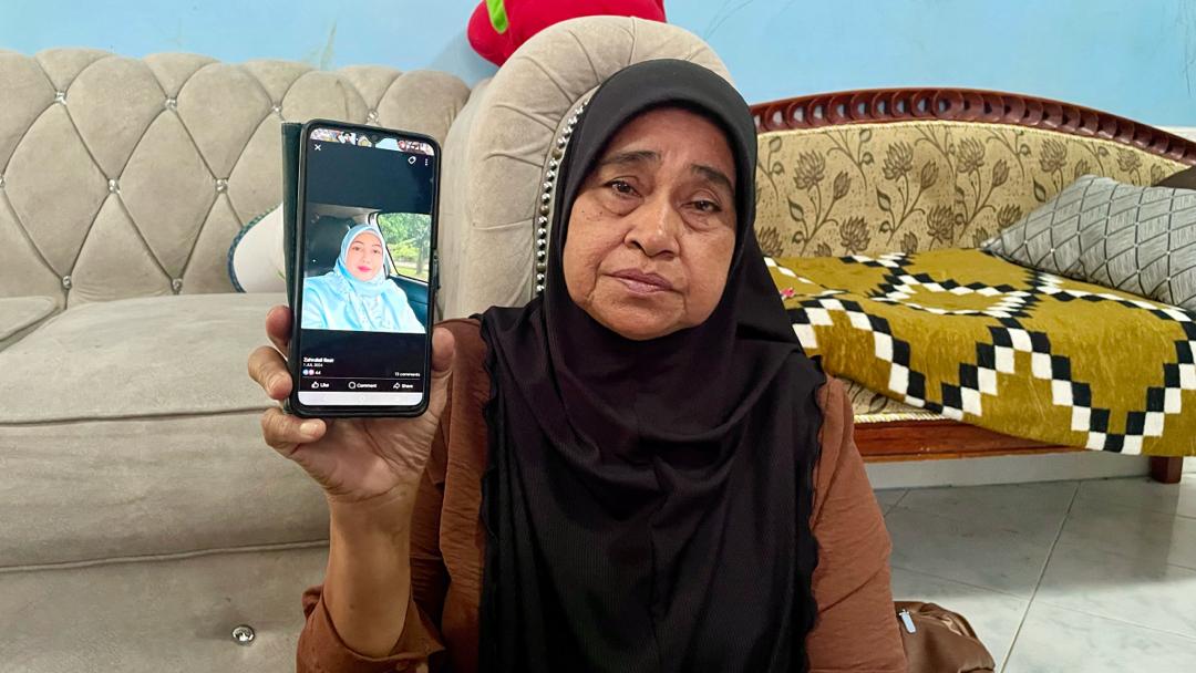 Zahrullai's mother holding her photo