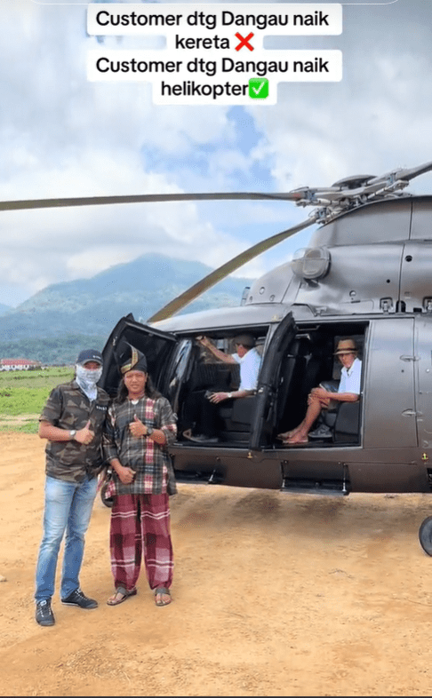 Zaidi Hassan takes photo with man and helicopter