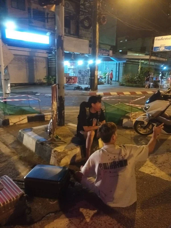 2 s'porean men sit by roadside after fight with security guard