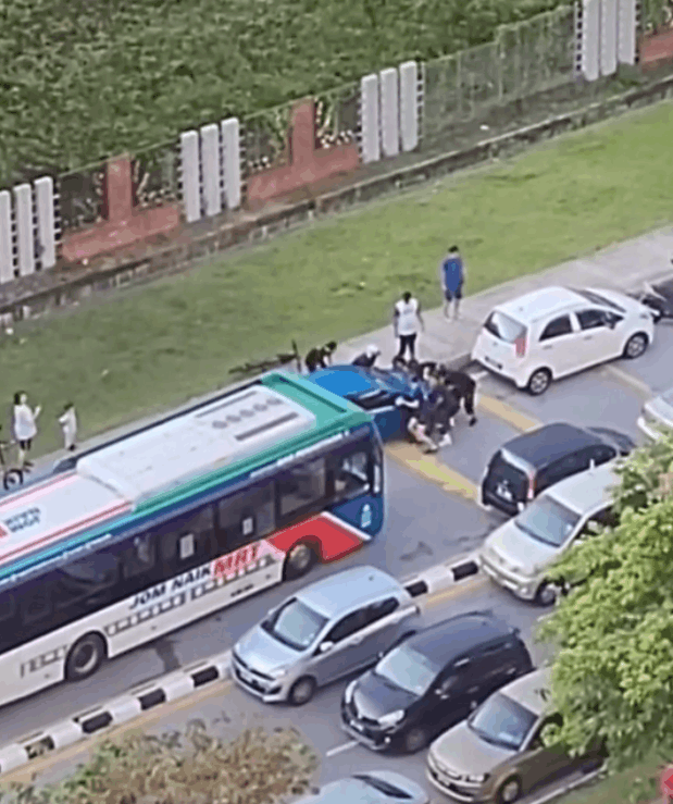 Malaysians unite to move an illegally parked car off the road