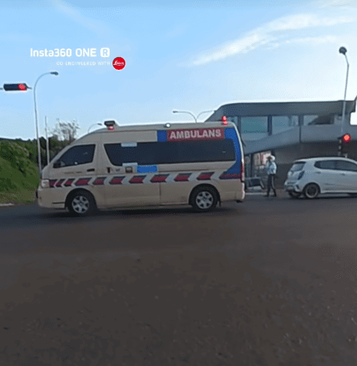 Traffic police direct ambulance