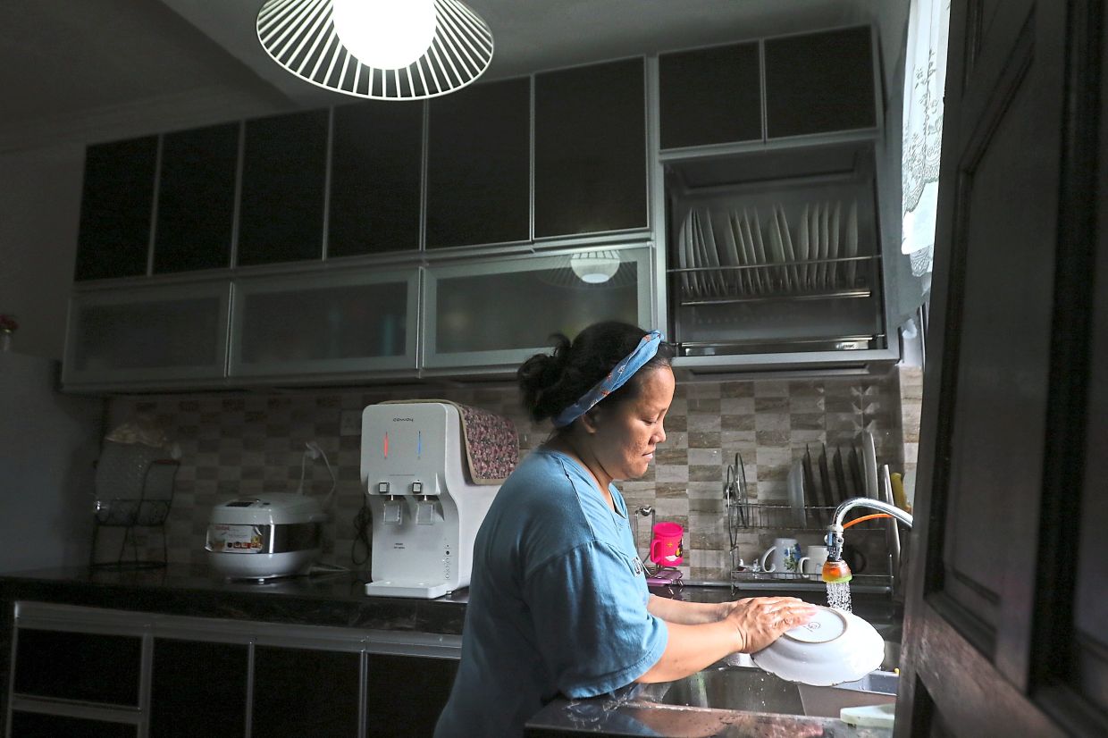 Asian maid washing dishes
