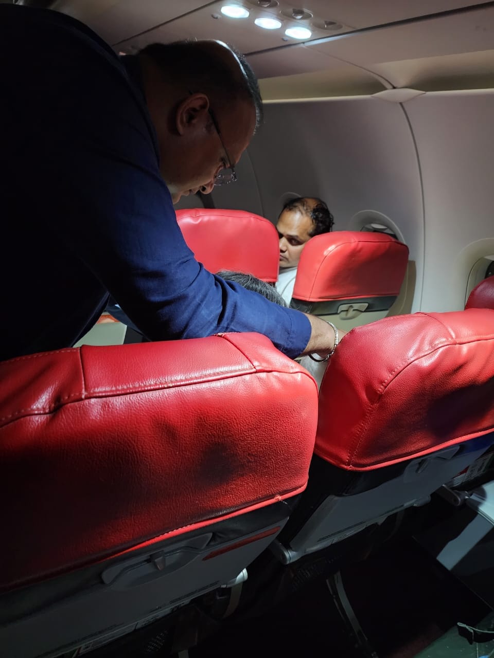 Dr. Sathia prakash nadarajan is checking the condition of a woman he treated on the flight.  