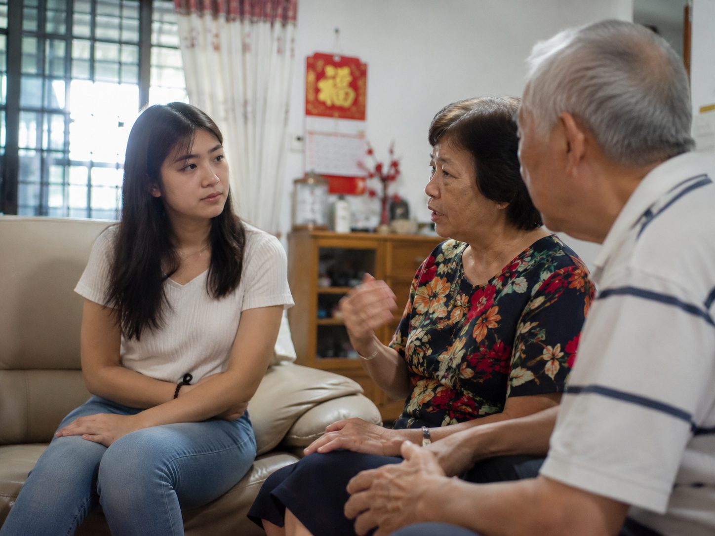 AI image of woman listening to older ppl talking