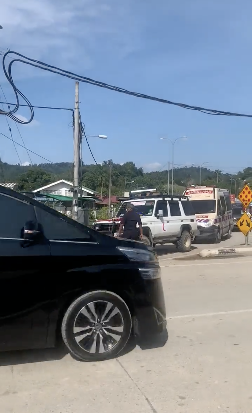 Ambulance with siren give way to convoy