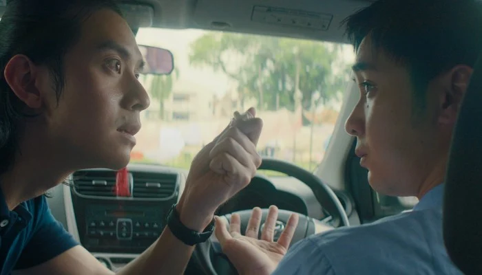 Brother arguing in car in movie rain town