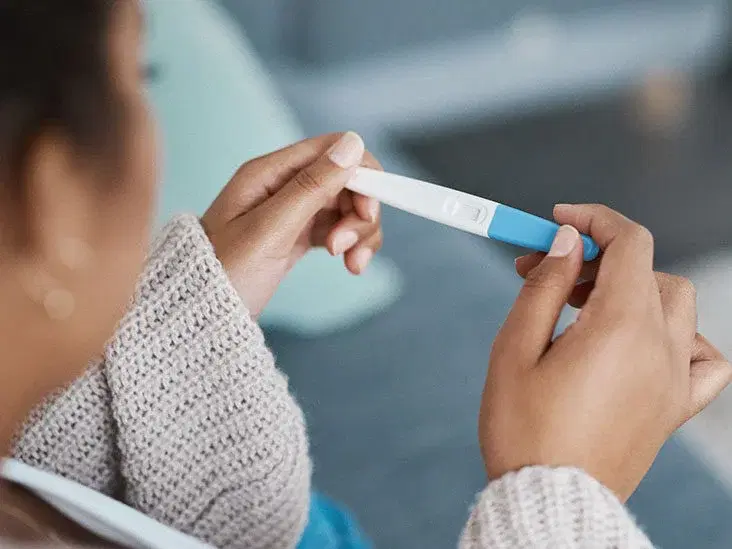 Woman checking her pregnancy test.