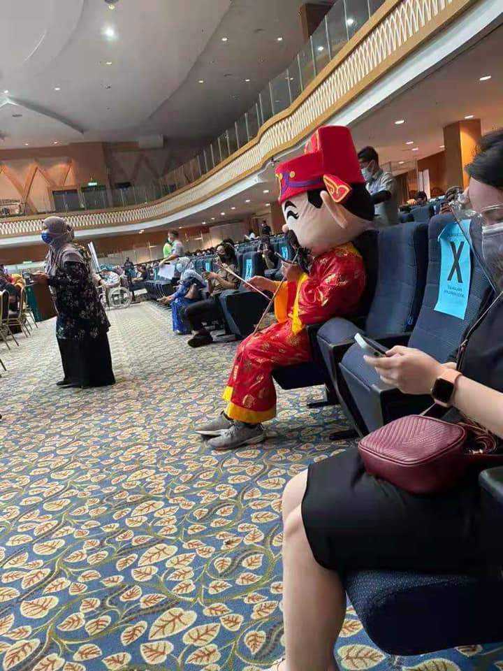 Man wearing god of fortune costume at uthm vaccination centre. Photo credit:jhonson ta