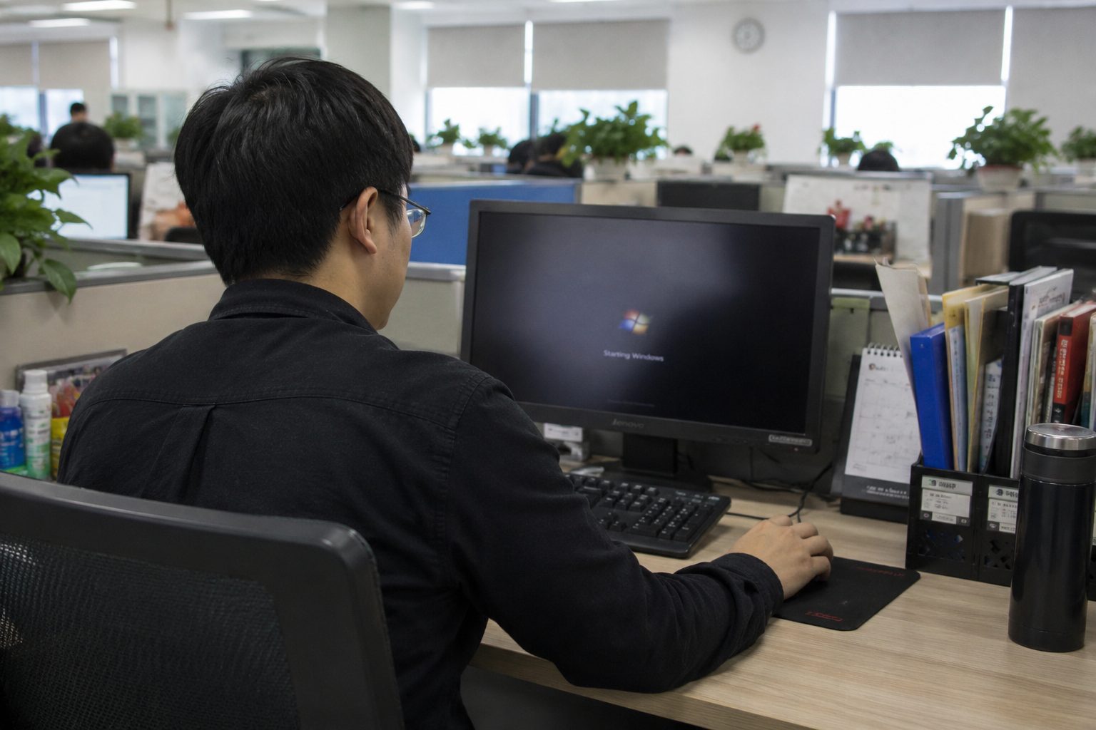 Man turning on computer