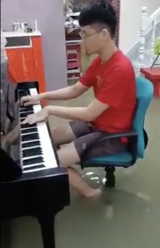 Mans play piano despite flooding in his house 04