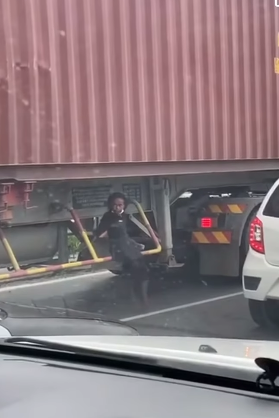 Kid sitting under moving truck