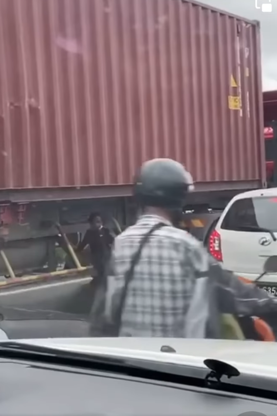 Kid sitting under moving truck