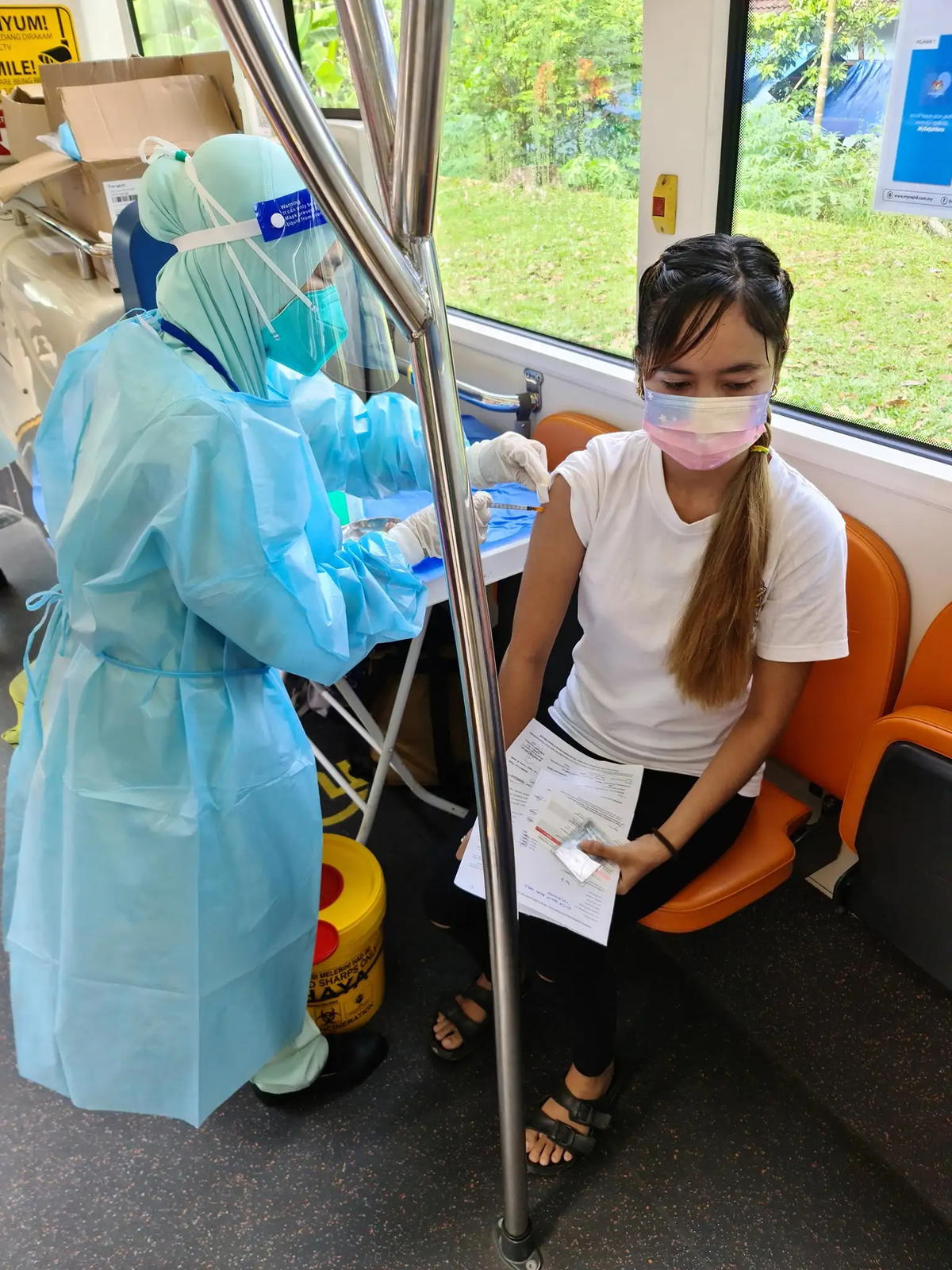 Orang asli receiving their vaccine at the mrt feeder bus. Credit: mrt corp