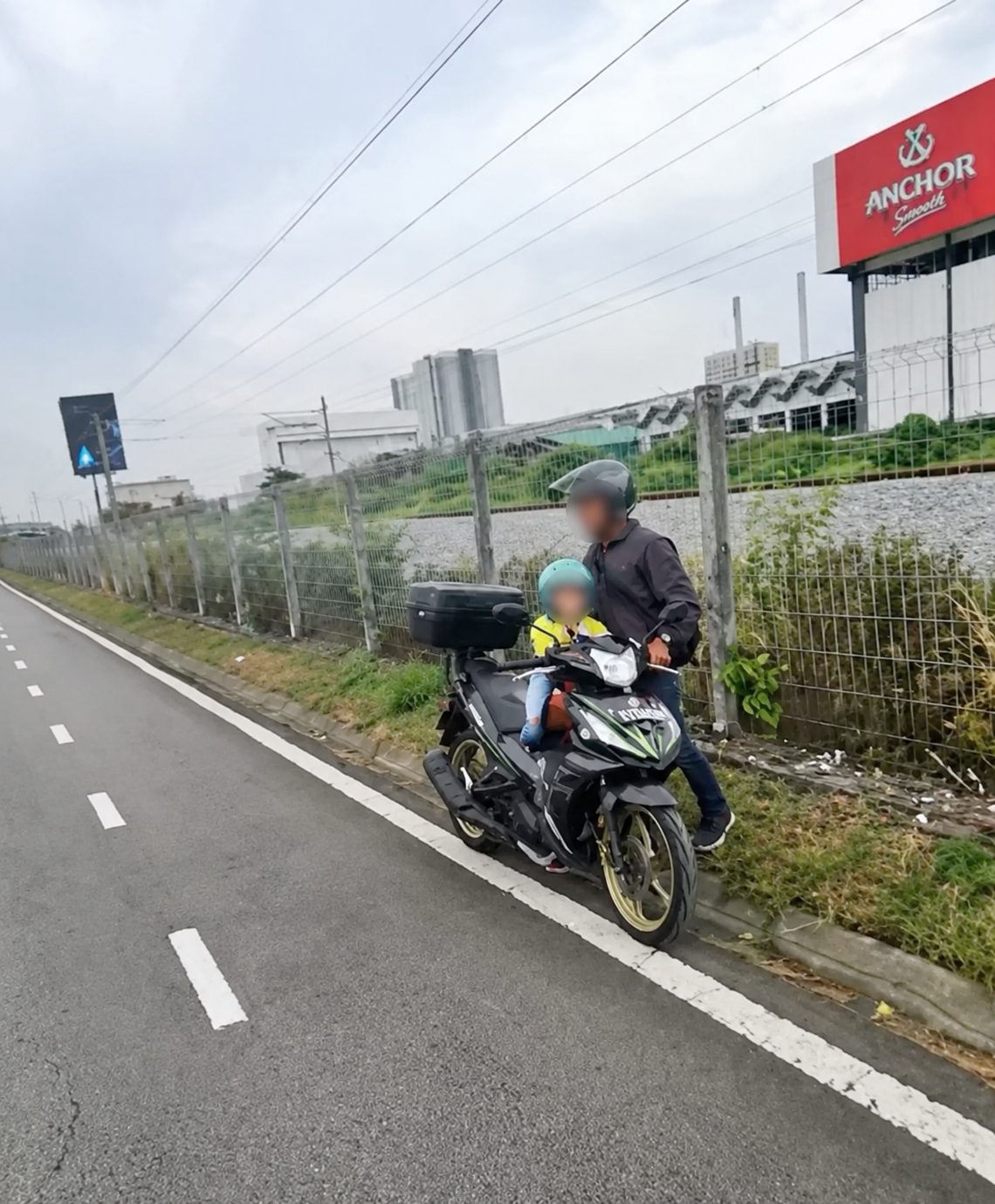 Policeman help father and son with motorcycle out of petrol