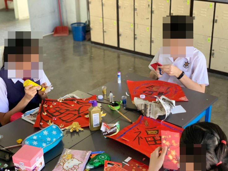 Students doing chinese new year decorations